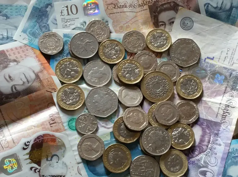 British pound notes and coins representing energy billing costs for landlords under Ofgem Maximum Resale Price rules