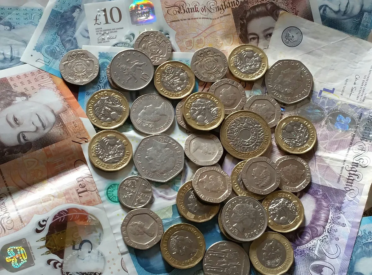 British pound notes and coins representing energy billing costs for landlords under Ofgem Maximum Resale Price rules